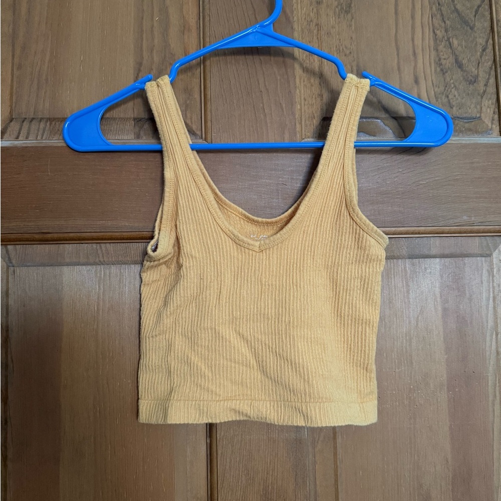 mustard yellow out from under tank top